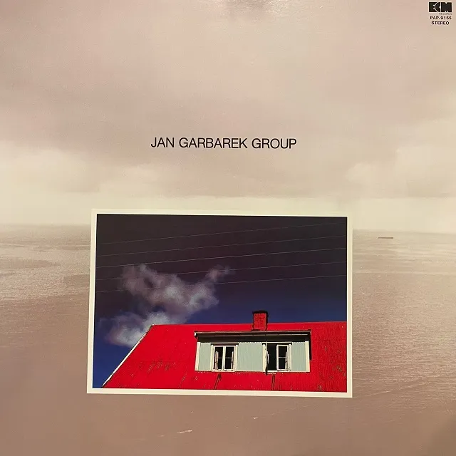 JAN GARBAREK GROUP / PHOTO WITH BLUE SKY, WHITE CLOUD, WIRES, WINDOWS AND A RED ROOF